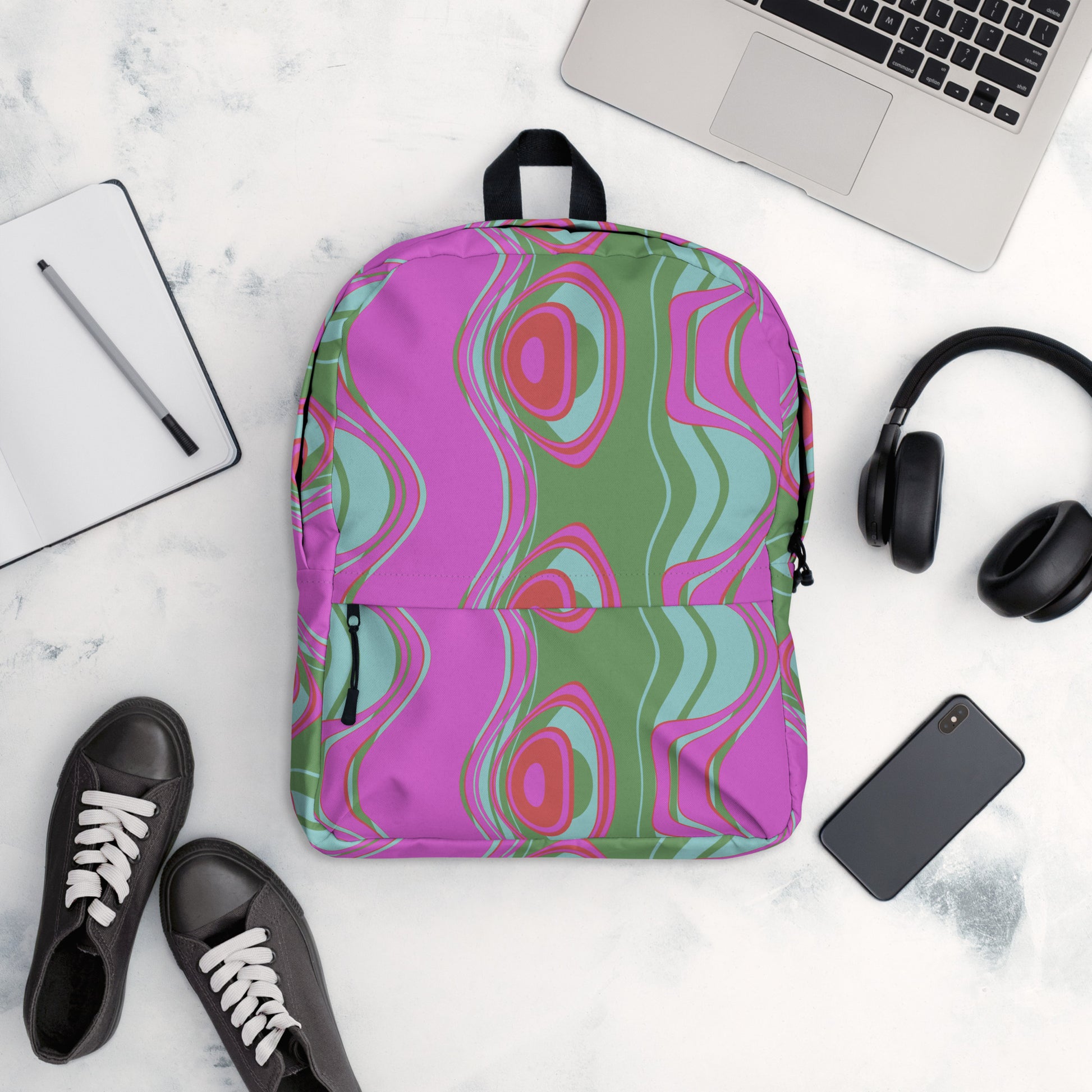 "The Far Out Wave" medium size backpack is just what you need for daily use or sports activities! The pockets (including one for your laptop) give plenty of room for all your necessities. While the water-resistant material will protect them from the weather.